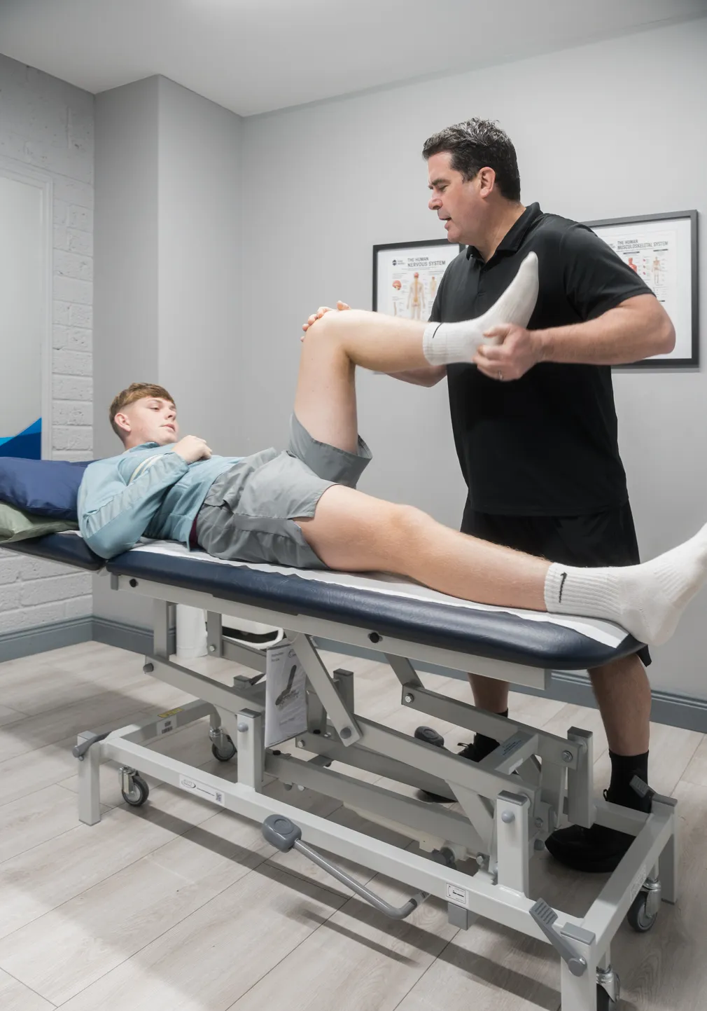 Physiotherapist examining a patient's knee